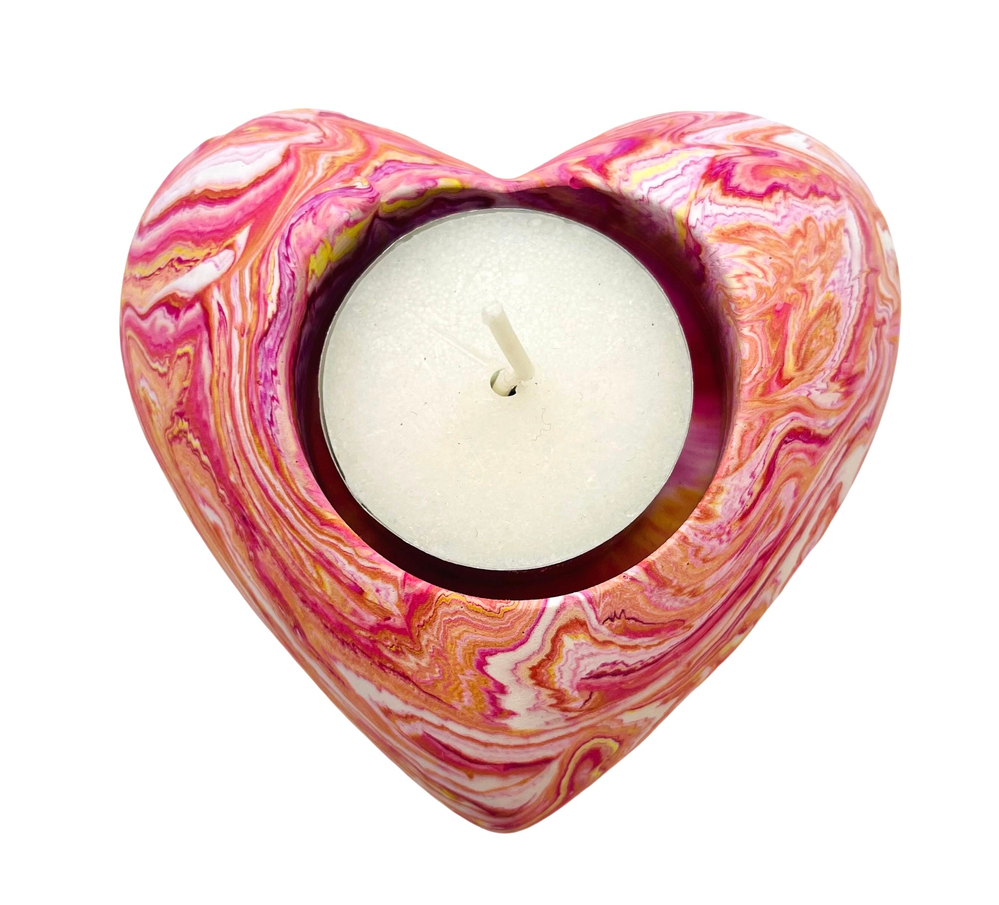 A Jesmonite heart shaped tealight holder measuring 9cm in width marbled with magenta and coral pigment.