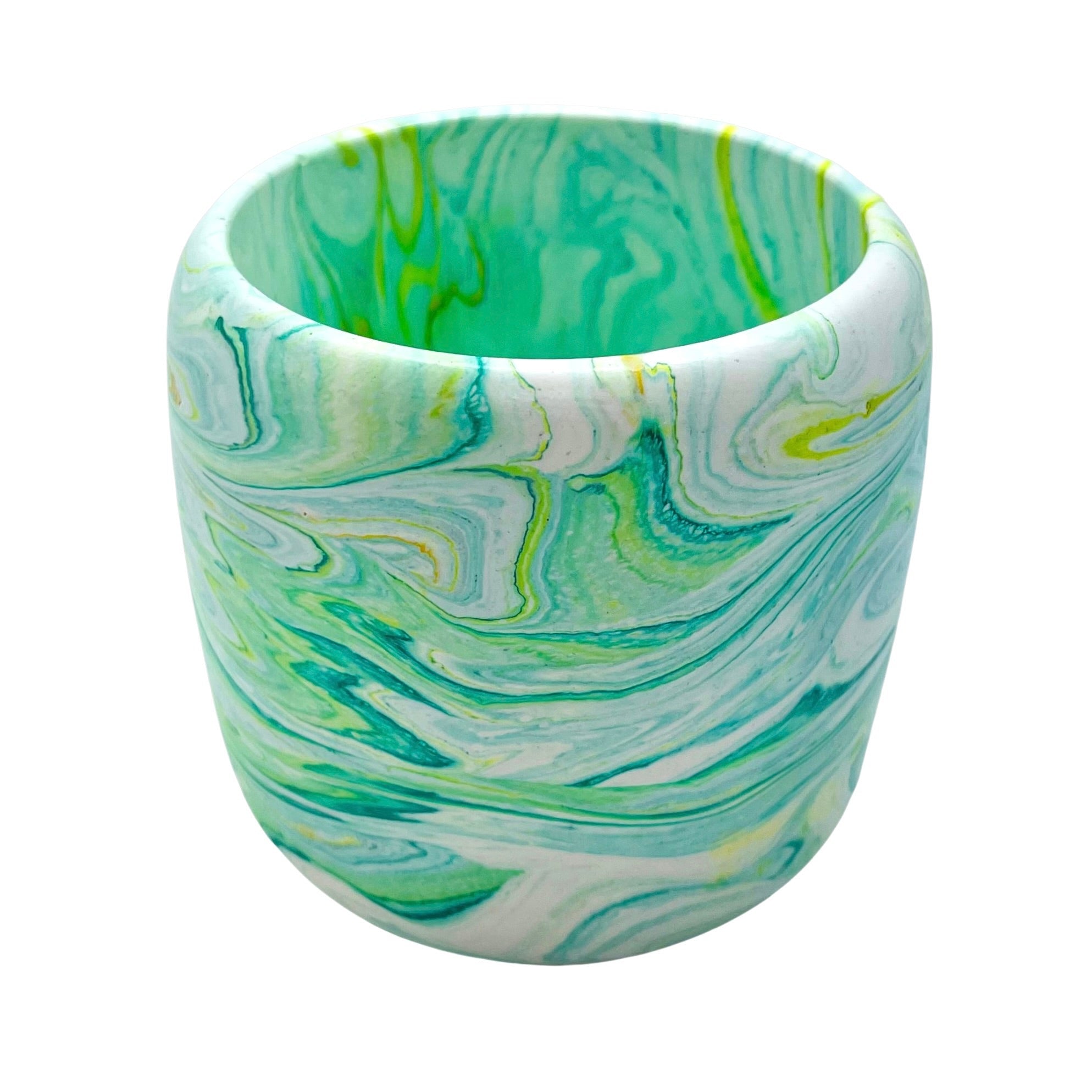 A Jesmonite tumbler with a 8.50cm diameter marbled with teal and lime green pigment.