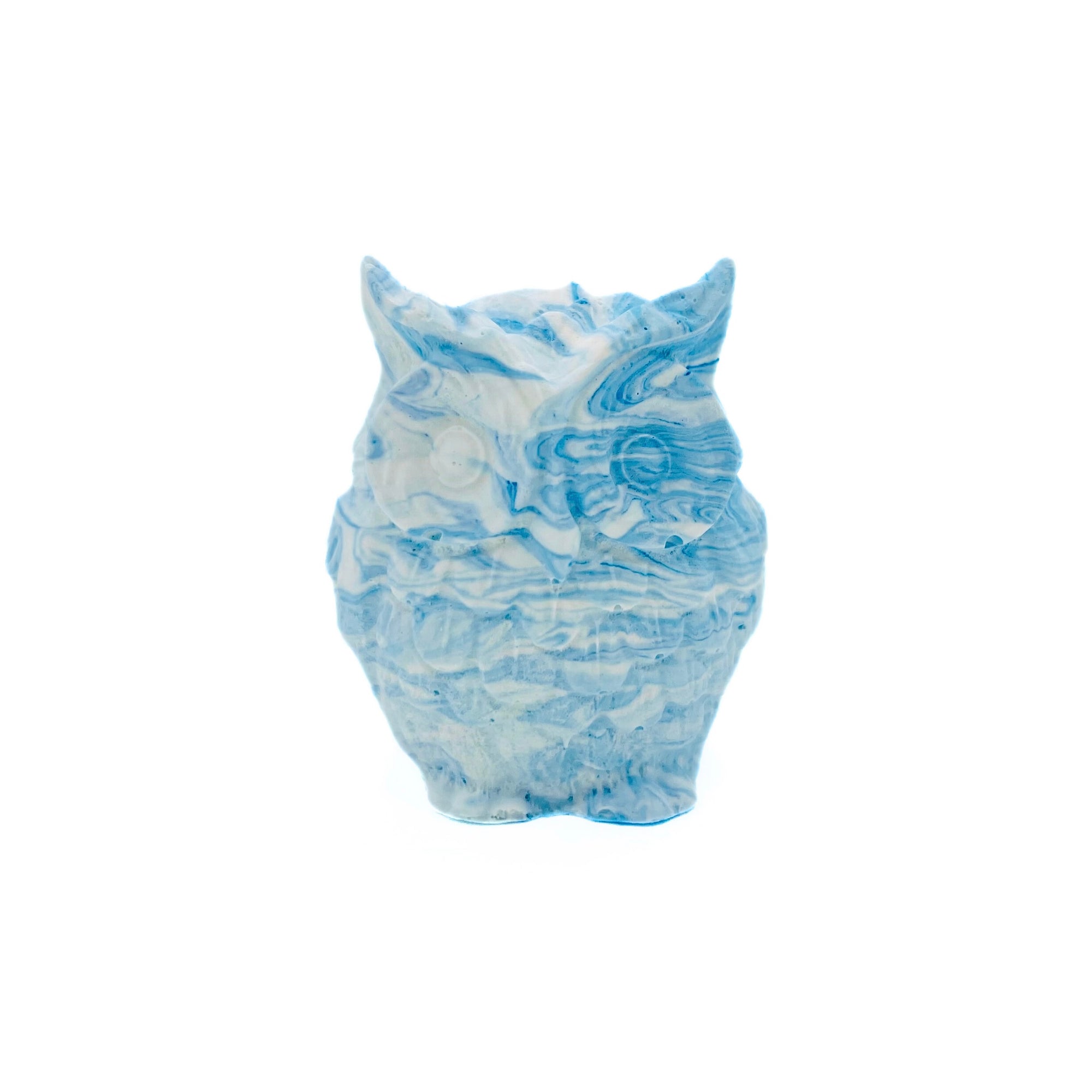A small owl made from Jesmonite measuring 5cm in height marbled with baby blue pigment.