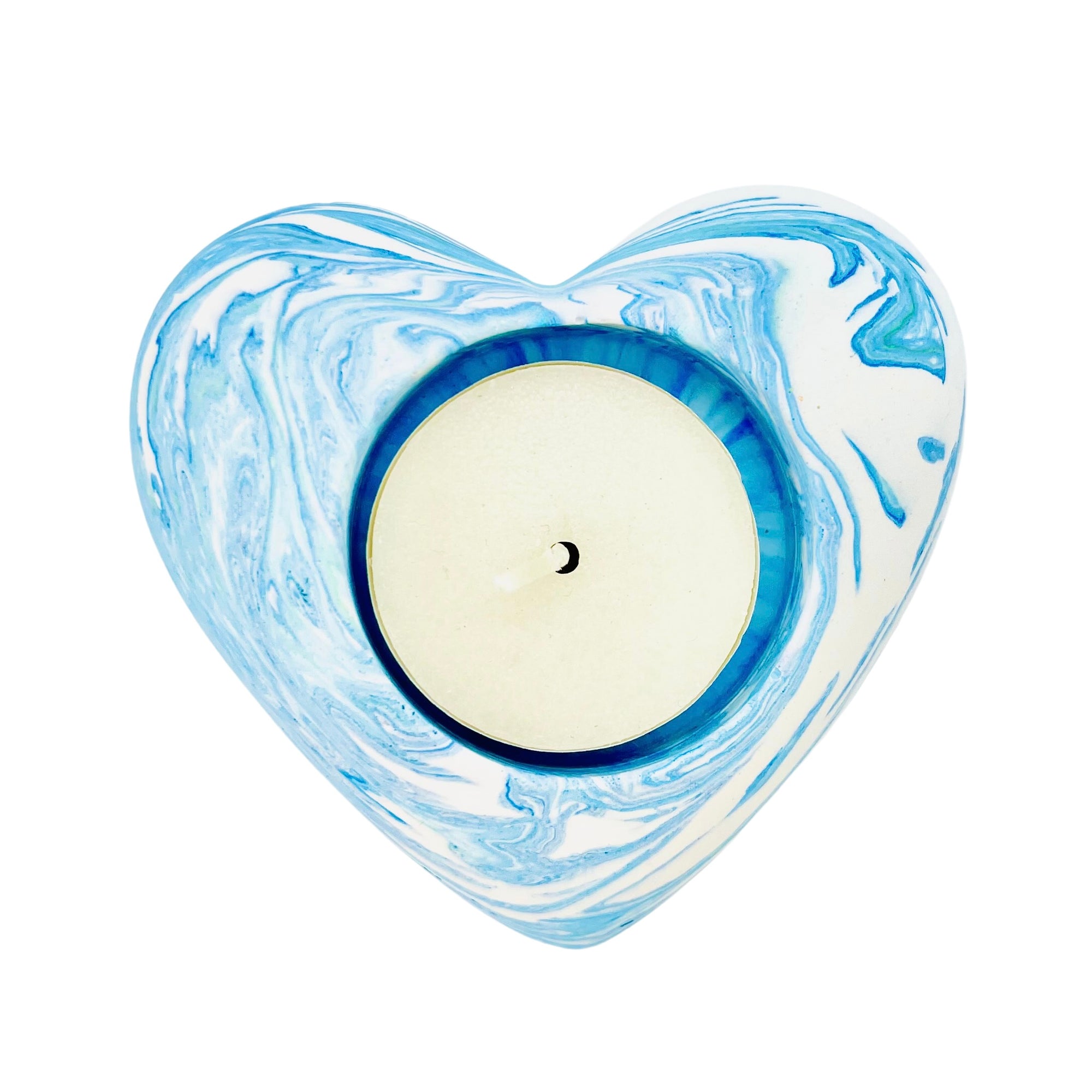 A Jesmonite heart shaped tealight holder measuring 9cm in width marbled with baby blue pigment. 