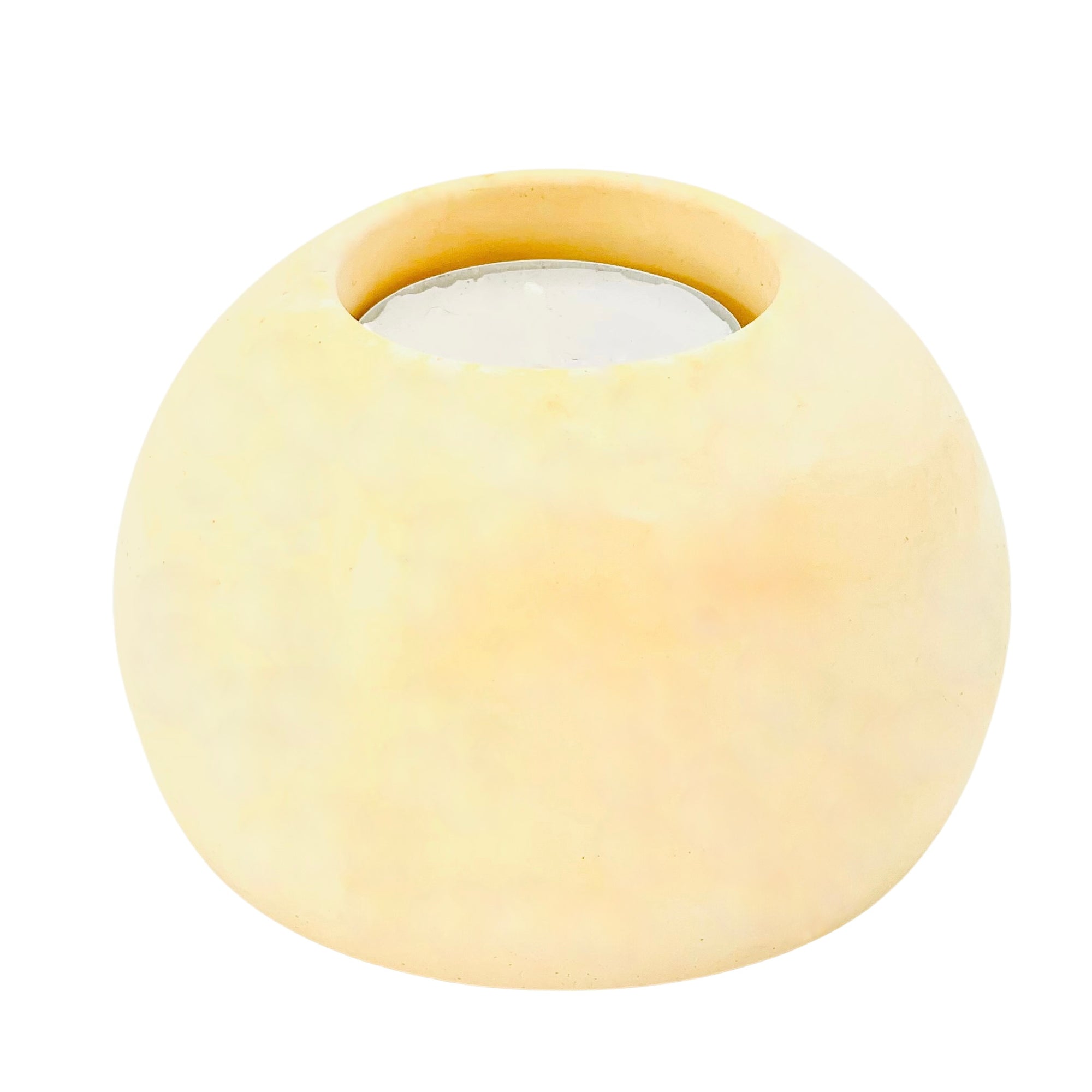 A solid Jesmonite spherical tealight holder measuring 9.2cm in diameter marbled with peach pigment.
