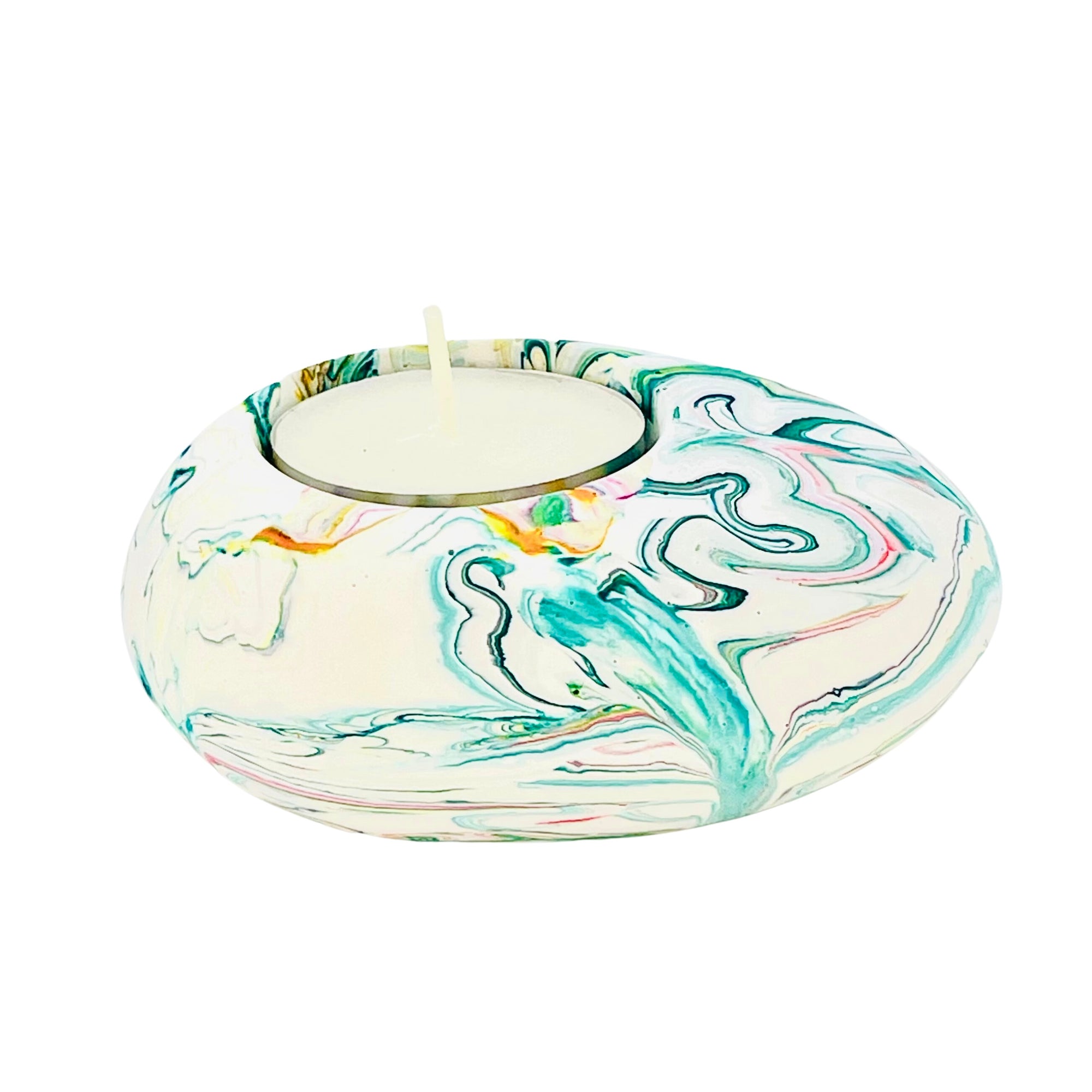 A Jesmonite tealight holder shaped like a pebble measuring 9cm in length and marbled with teal pigment.