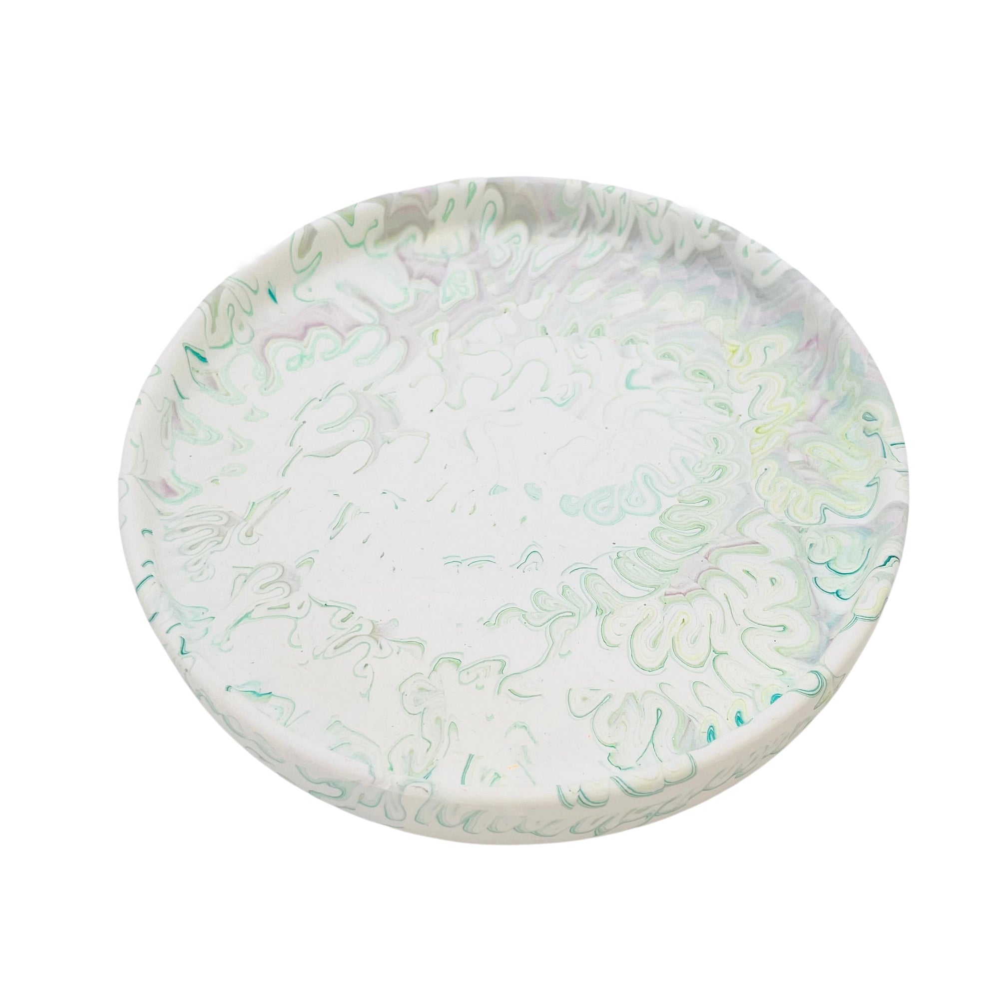 A circular Jesmonite trinket tray measuring 15.4cm in diameter marbled with sage green  pigment.