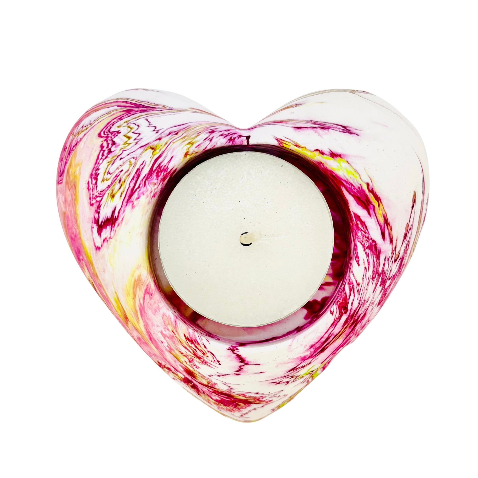 A Jesmonite heart shaped tealight holder measuring 9cm in width marbled with magenta and yellow pigment.