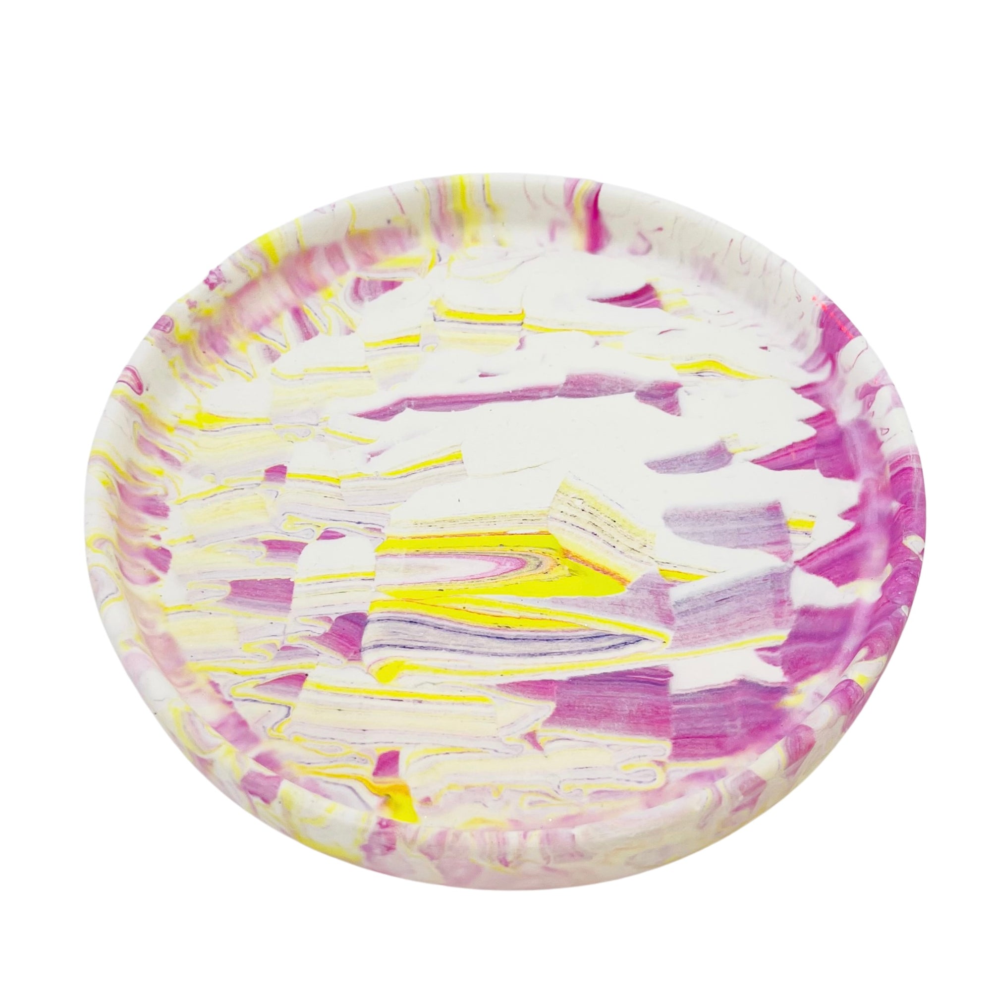 A circular Jesmonite trinket tray measuring 15.4cm in diameter marbled with magenta and yellow pigment.