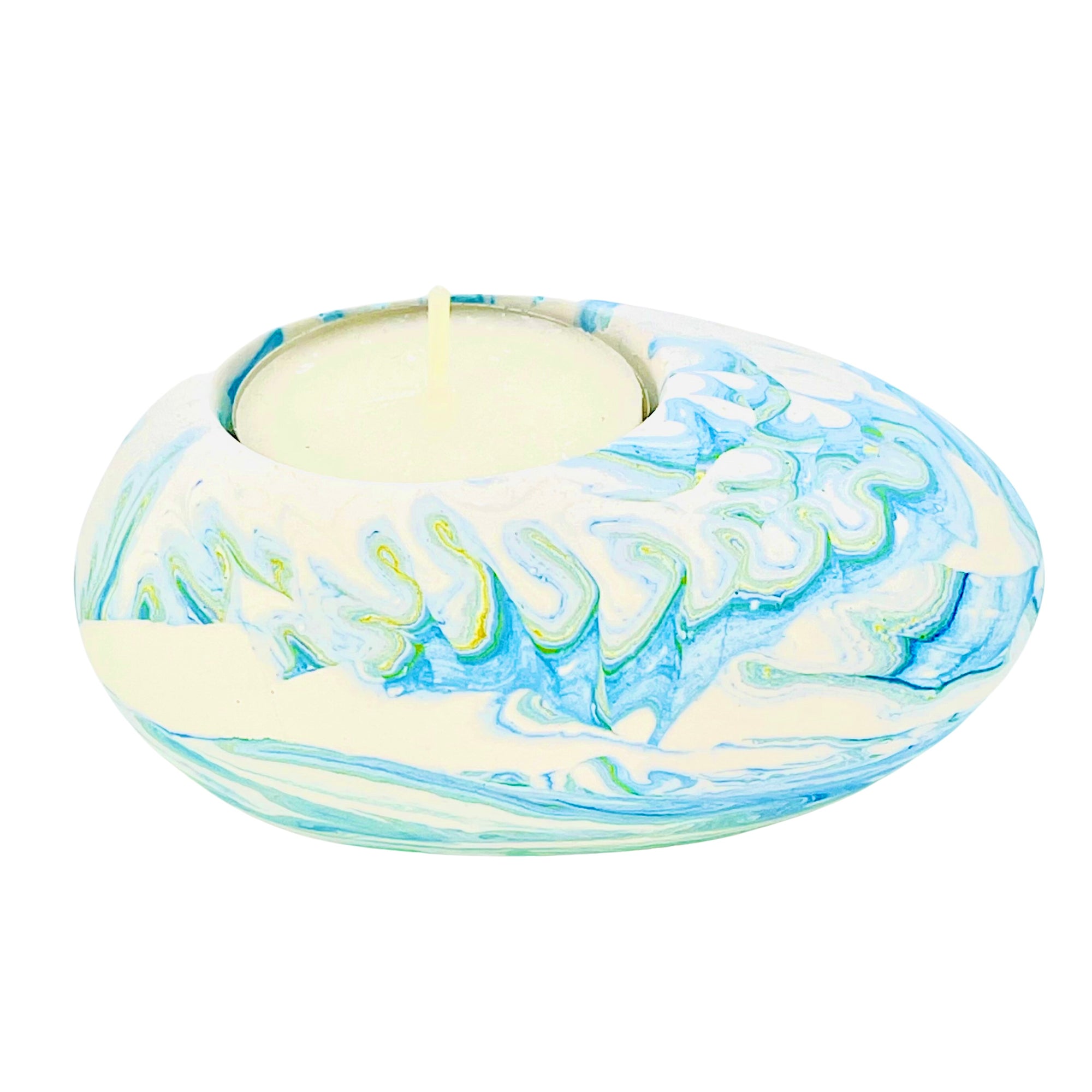 A Jesmonite tealight holder shaped like a pebble measuring 9cm in length and marbled with baby blue pigment.