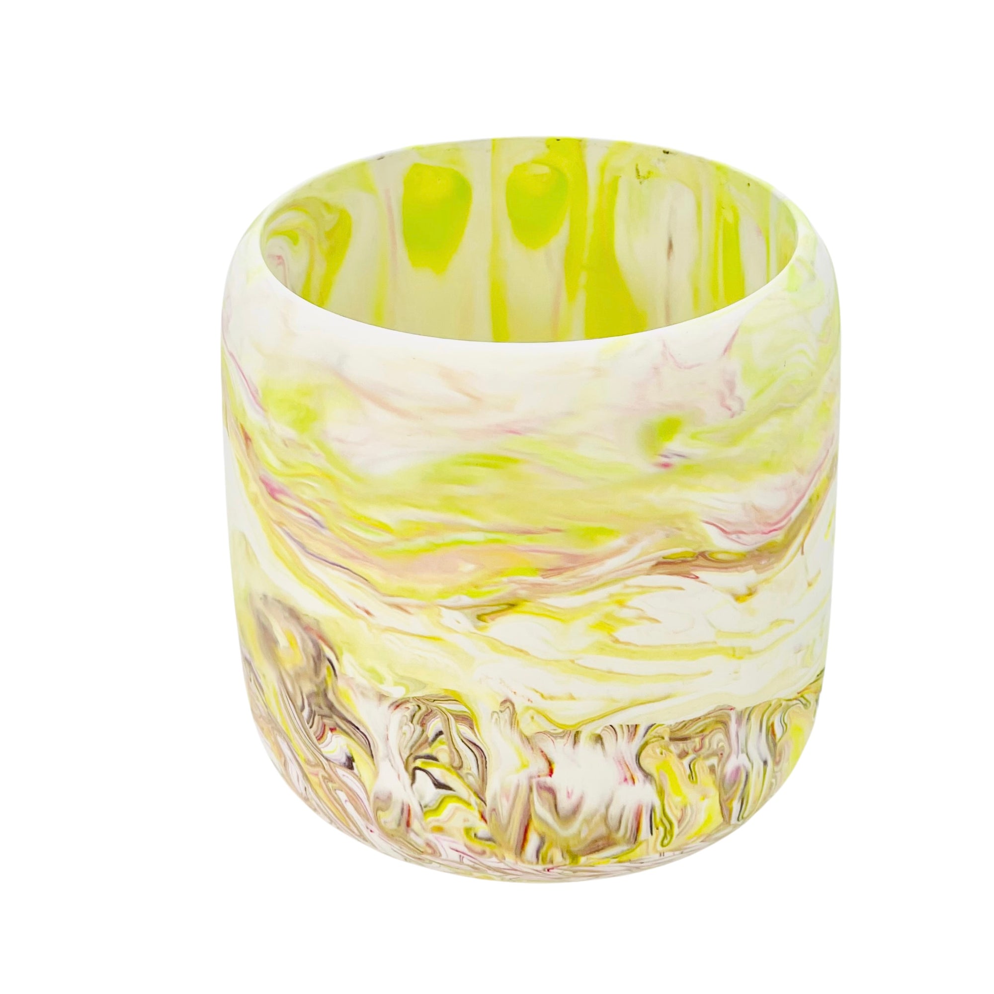 A Jesmonite tumbler with a 8.50cm diameter marbled with lime green and magenta pigment.