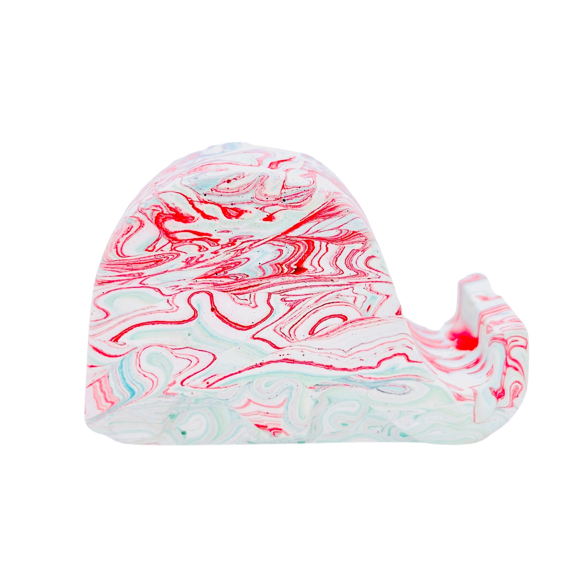A Jesmonite elephant mobile phone stand measuring 6.5cm in length marbled with red and turquoise pigment.
