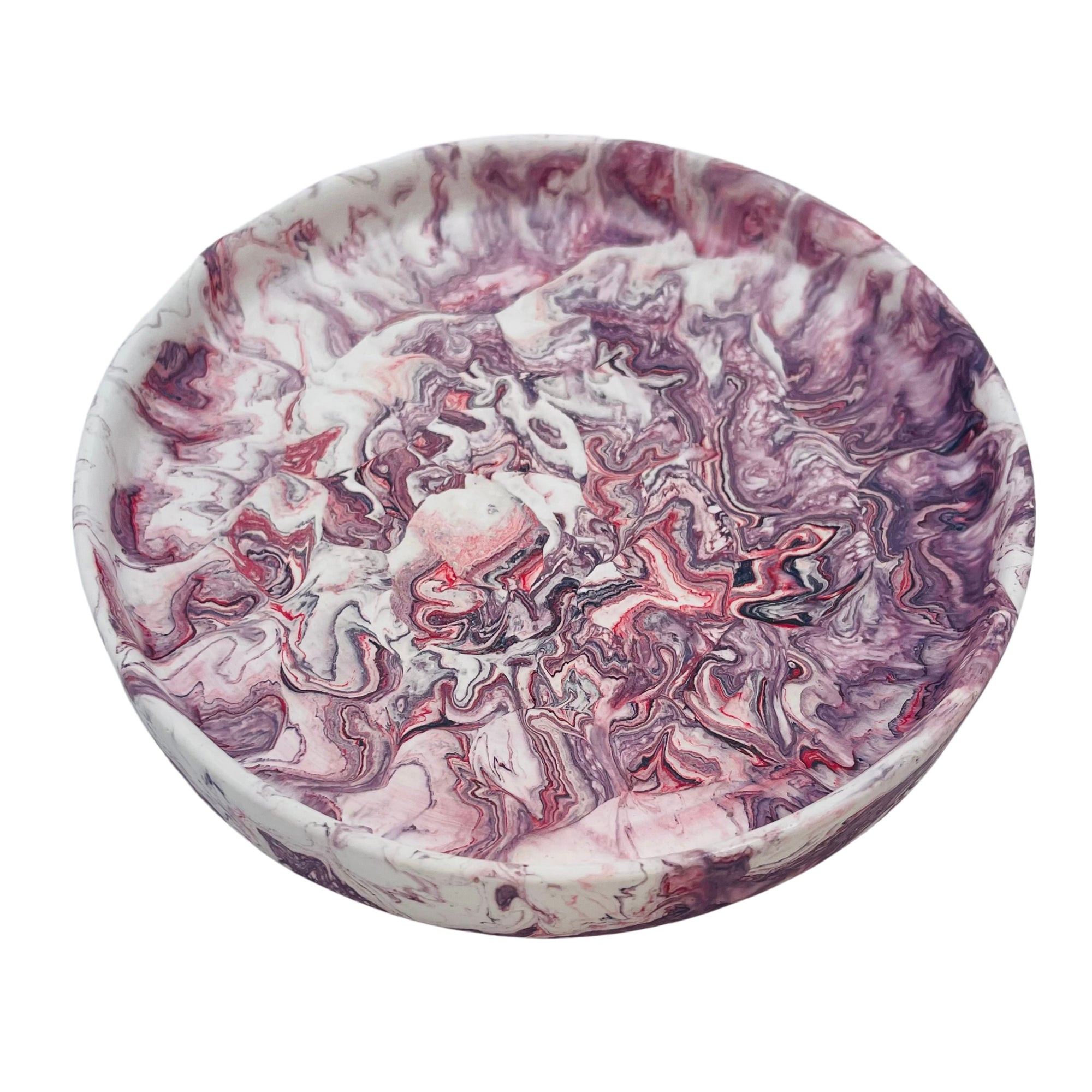 A circular Jesmonite trinket tray measuring 15.4cm in diameter marbled with aubergine pigment.