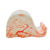 A Jesmonite elephant mobile phone stand measuring 6.5cm in length marbled with orange pigment.
