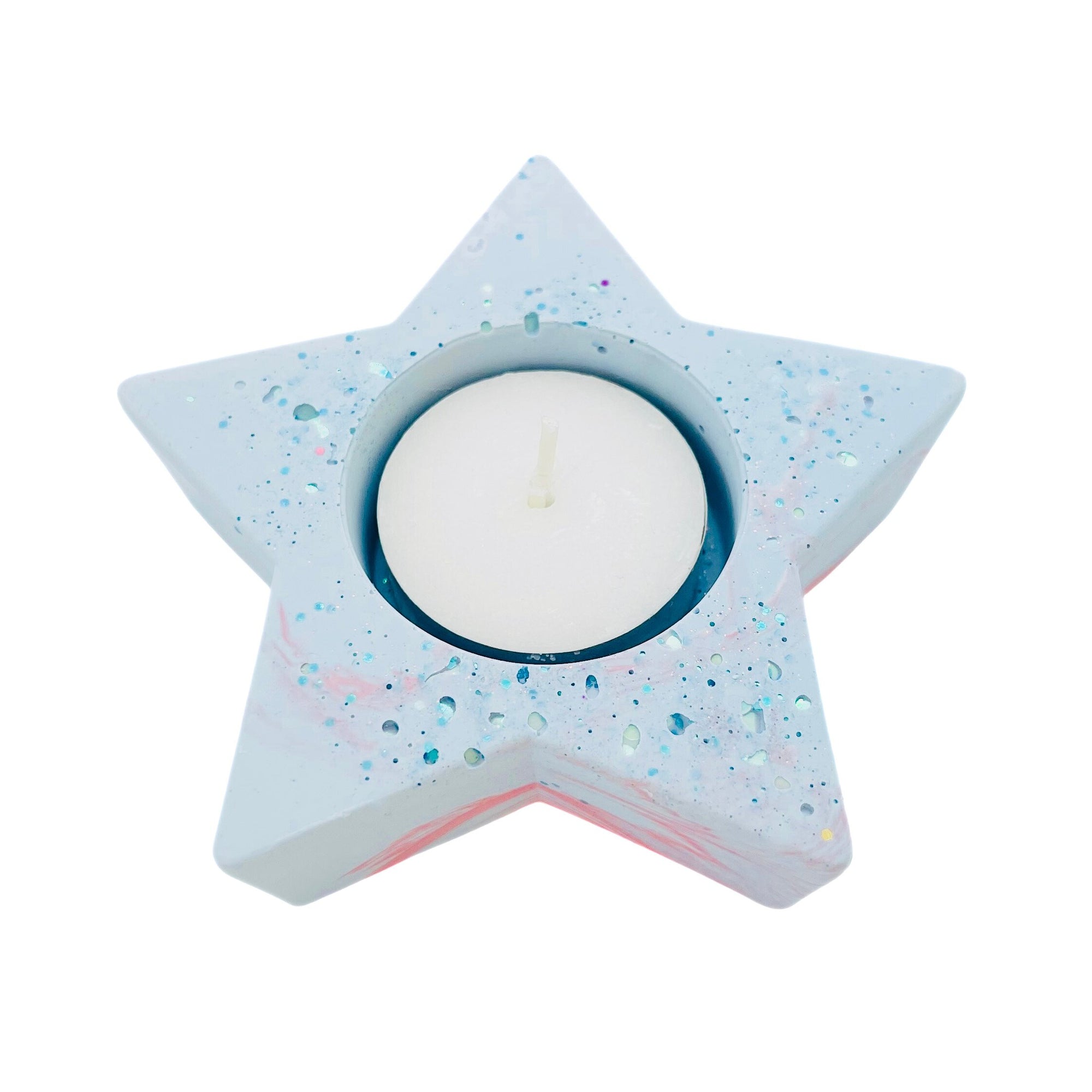 A star shaped Jesmonite tealight holder measuring 10cm in width marbled with powder blue and coral pigment sprinkled with blue glitter.