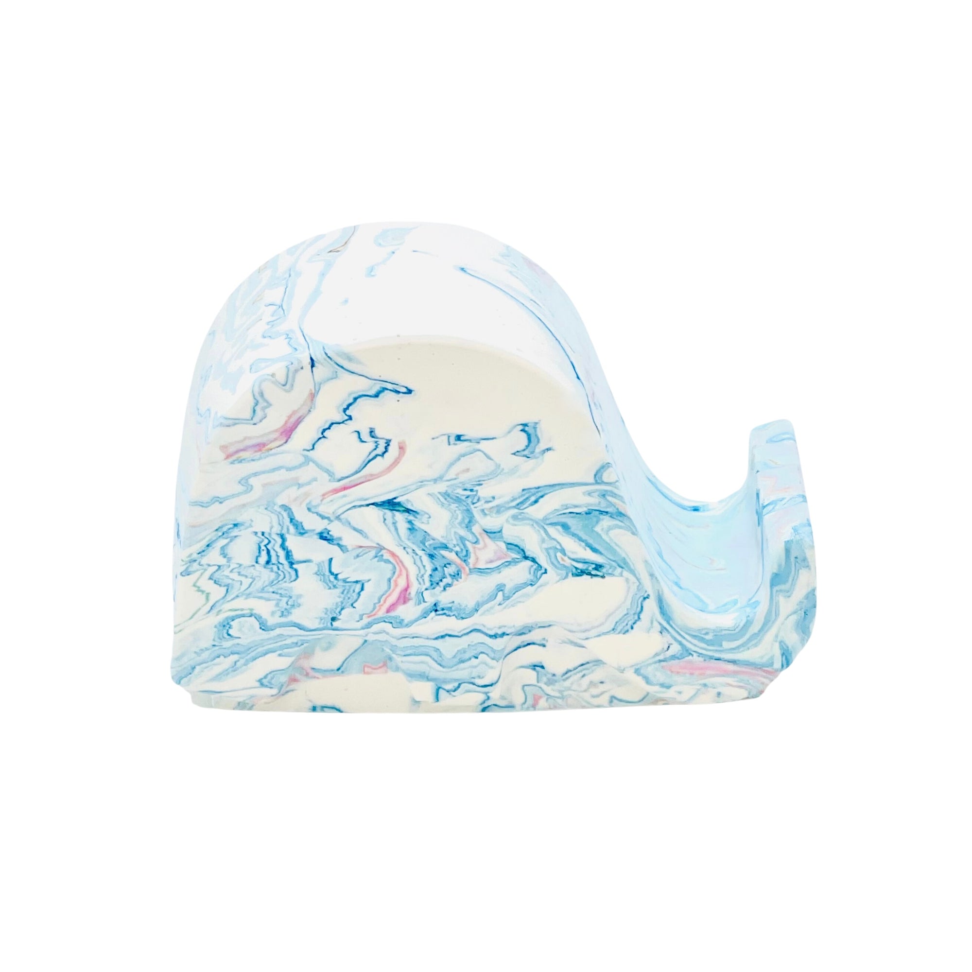 A Jesmonite elephant mobile phone stand measuring 6.5cm in length marbled with baby blue pigment.